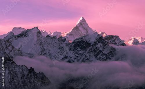 Game of tender pink halftones at sunrise; majestic Ama Dablam peak (6856 m) in Nepal, Himalayas mountains. Greatness of nature concept