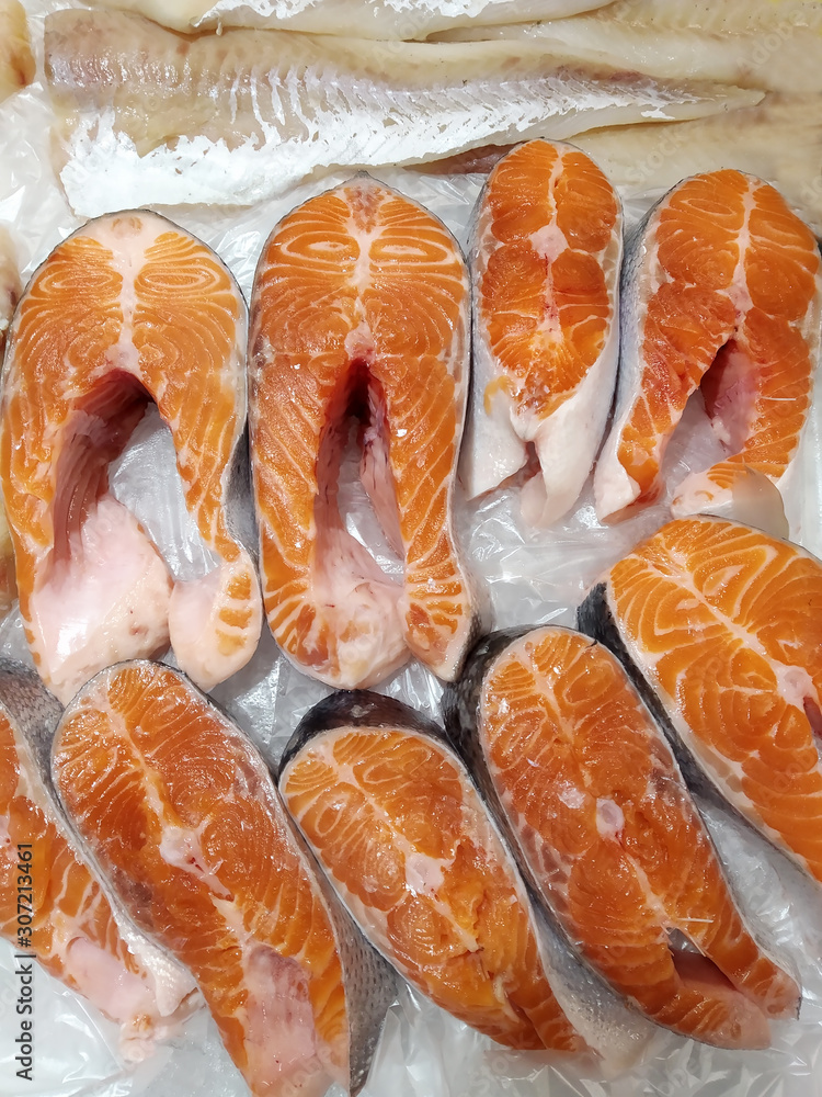 Steaks of fresh chilled red fish on the store counter lined with ice Steaks of fresh chilled red fish on the store counter lined with ice