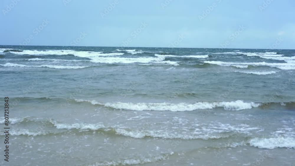 amazing ocean waves cover water surface and create white thick foam under clear blue sky against horizon slow motion amazing ocean waves cover water surface and create white thick foam under clear blue sky against horizon slow motion