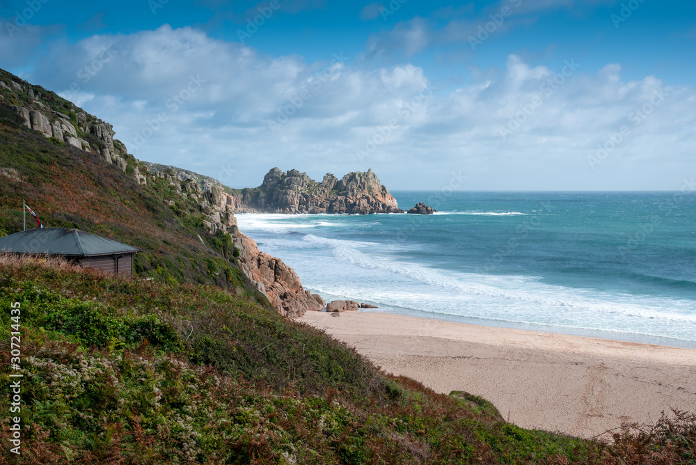 View of Porthcurno Beach in south Cornwall on a cloudy September day.