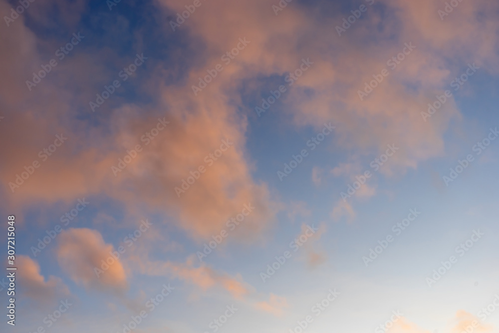 Beautiful sky background with tender pink sunset clouds.