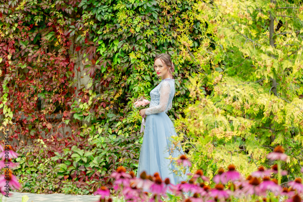 in a blue wedding dress, the bride with a bouquet, in the colors of the botanical garden sunny day in summer in a blue wedding dress, the bride with a bouquet, in the colors of the botanical garden sunny day in summer