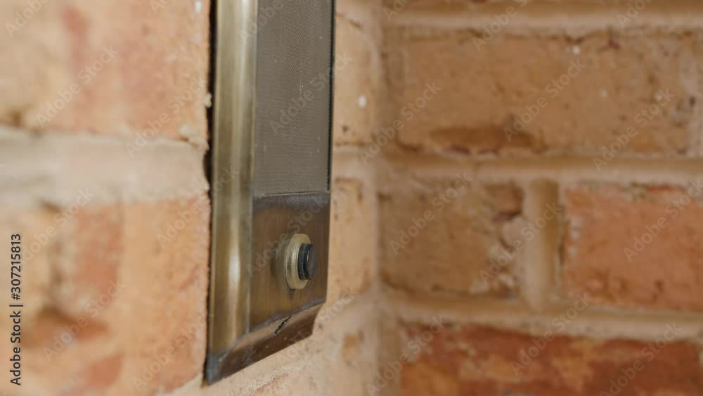 Ringing doorbell with thumb. Closeup of male hand pushing home intercom door bell button. Ringing doorbell with thumb. Closeup of male hand pushing home intercom door bell button.