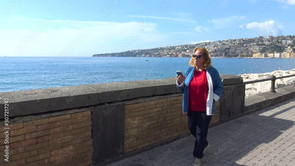 Italy, Naples, blonde tourist poses on the waterfront Italy, Naples, blonde tourist poses on the waterfront