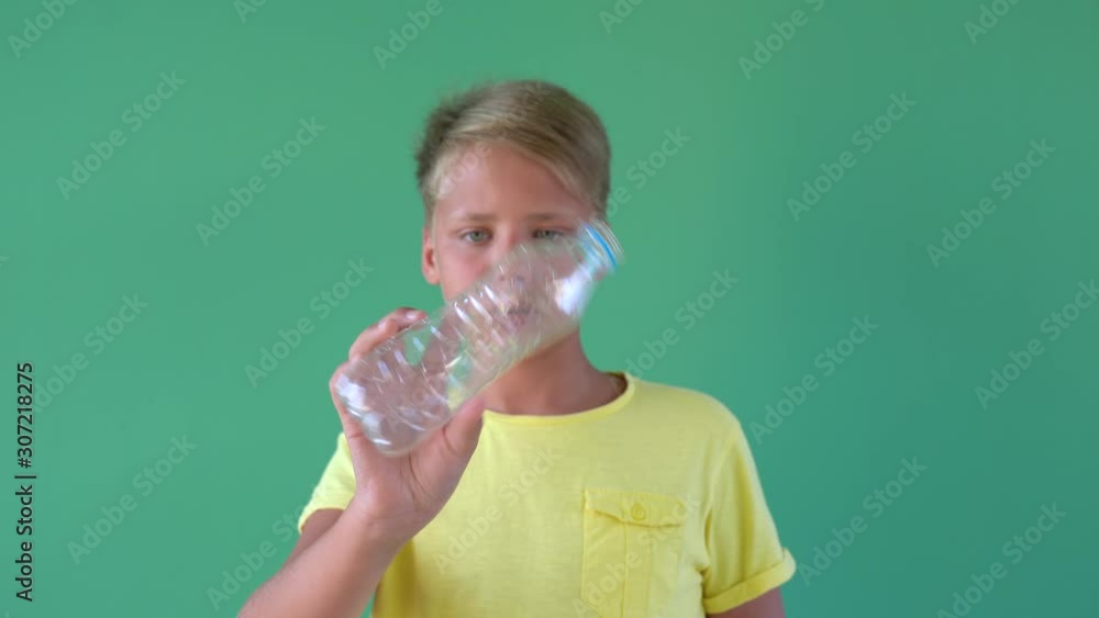 Closeup view of young kid hands holding one empty plastic crumpled bottles in hands. Real time 4k video footage. Closeup view of young kid hands holding one empty plastic crumpled bottles in hands. Real time 4k video footage.