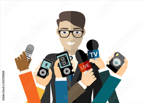 Business man giving an interview in the presence of journalists with microphones.