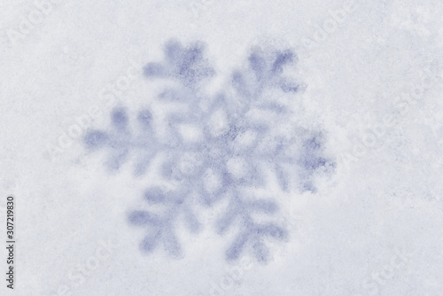 Close-up snowflake toy in the snow