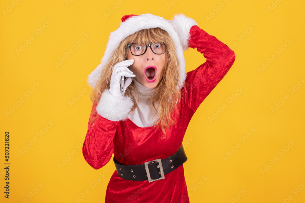 santa claus woman with mobile phone isolated on color background santa claus woman with mobile phone isolated on color background