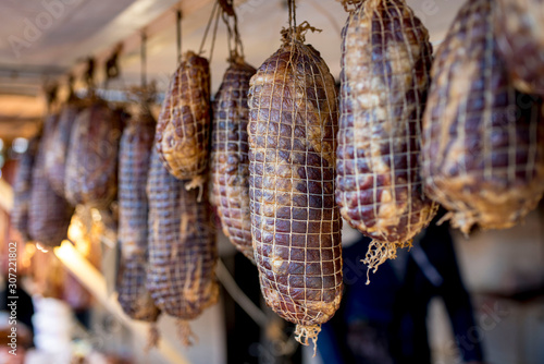 Food stand with smoked boneless pork ham wrapped in netting