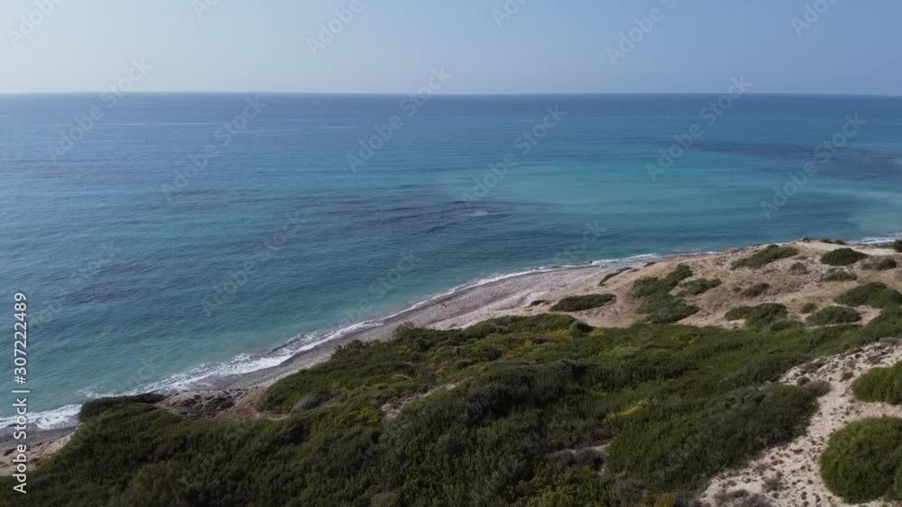 Aerial travel over the land, beach and shore near Petra Tou Romiou in Paphos, Cyprus, showing the diverse terrain. Aerial travel over the land, beach and shore near Petra Tou Romiou in Paphos, Cyprus, showing the diverse terrain.