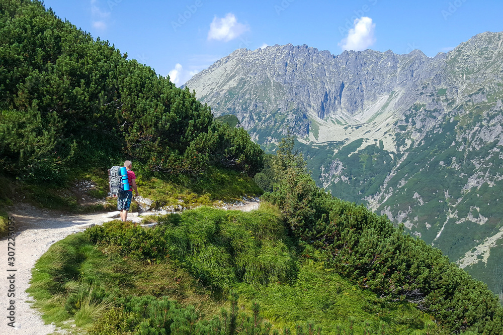 tourist walks along path in the mountains