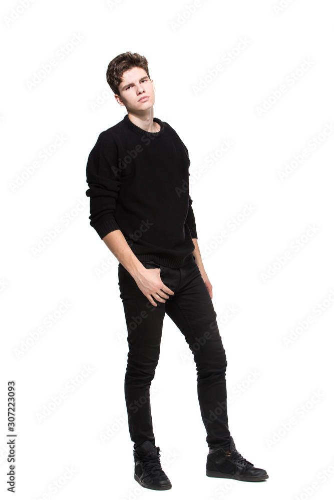 Young male model in black clothes posing in studio white background.  Caucasian guy in stylish clothes sweater and jeans isolate. Fashion model  young white man Stock Photo | Adobe Stock
