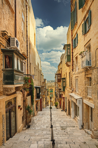 Narrow street with stairs in Valleta with traditional houses