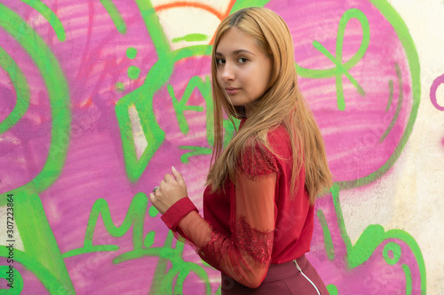 Girl at the wall with graffiti © Gribanov