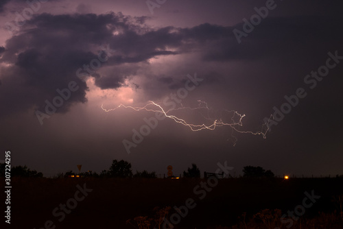 Dramatic nature scene with lightning bolt splitting through the night sky