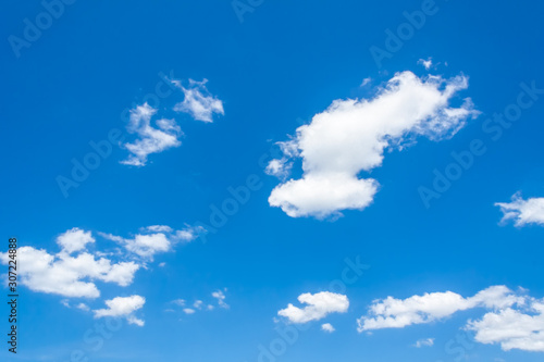 White fluffy cumulus clouds in the blue sky