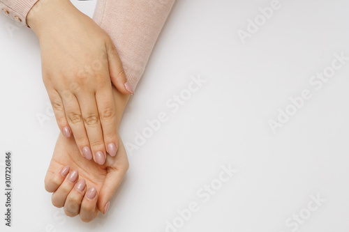 Clean woman hands with manicure close-up. Dermatology and hands care concept.