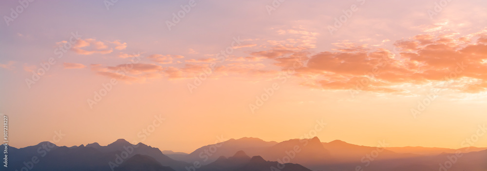 Obraz premium Panoramic mountains view. Beutiful sky and clouds after sunset. Landscape background.