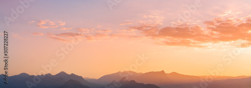 Panoramic mountains view. Beutiful sky and clouds after sunset. Landscape background.