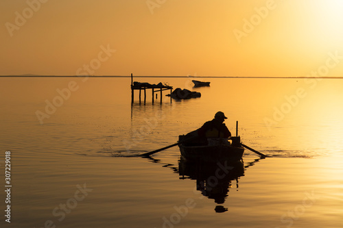 silhouette of a fisherman at sunset
