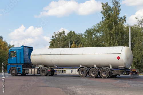 A gas tanker on a city highway