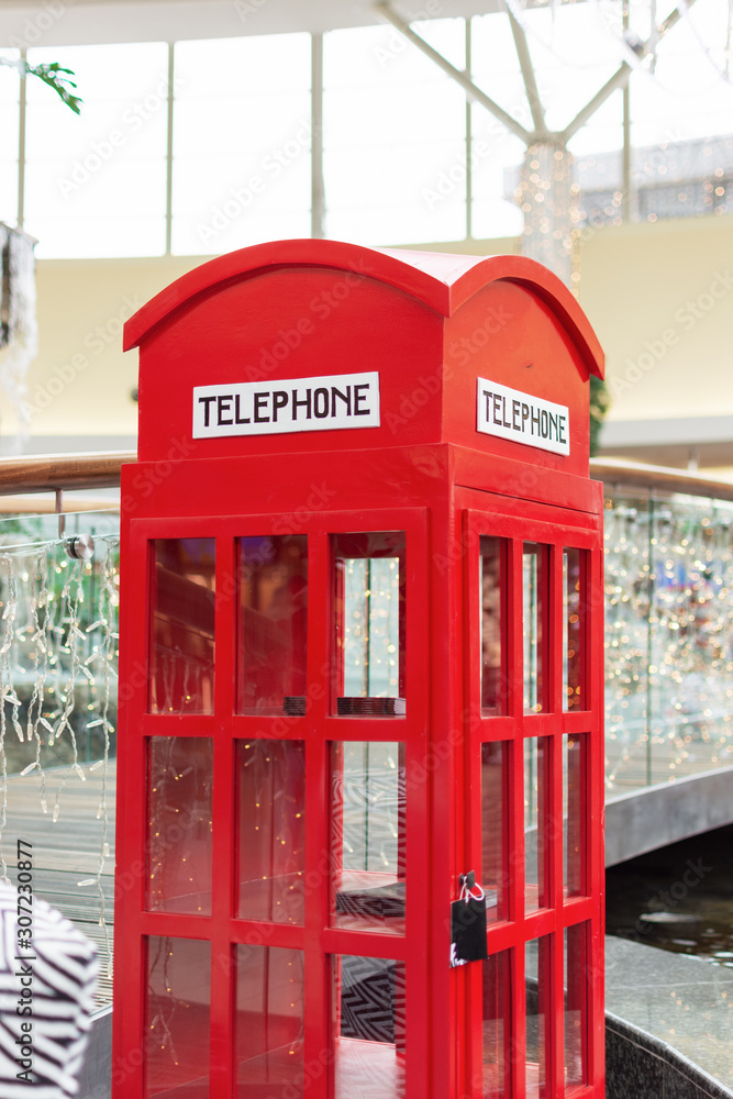 London style red public telephone booth intoor on Christmas time. London style red public telephone booth intoor on Christmas time.