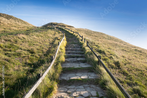 Photo Stone steps leading up hill, journey concept of one step at a time