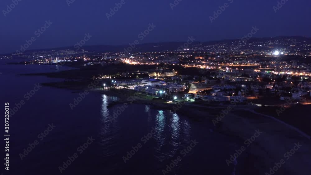 Aerial view of Paphos embankment or promenade at night with reflection of city lights in sea water. Famous Cyprus mediterranean resort Aerial view of Paphos embankment or promenade at night with reflection of city lights in sea water. Famous Cyprus mediterranean resort