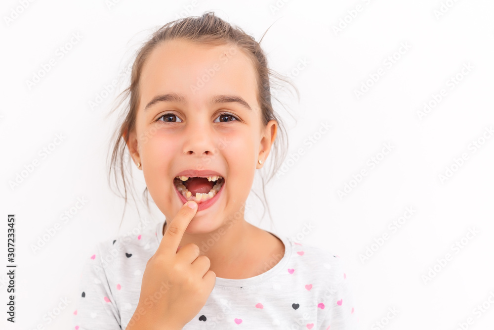Little girl first tooth missing on a white background Little girl first tooth missing on a white background