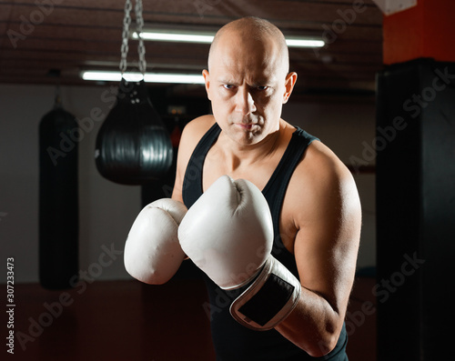 Potrait of man boxer who is training in gym © JackF