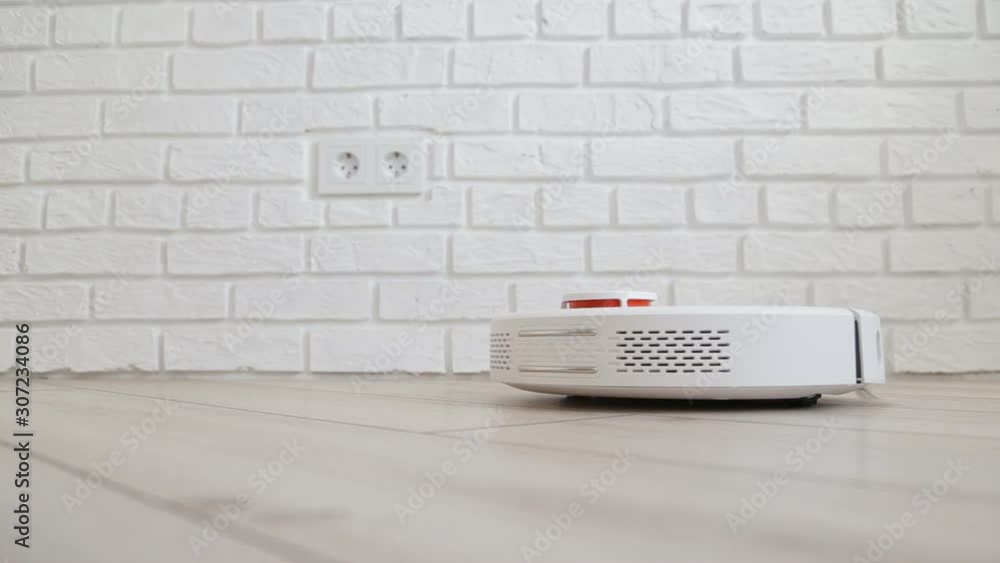 Robot vacuum cleaner enters the frame and stops and enters standby mode