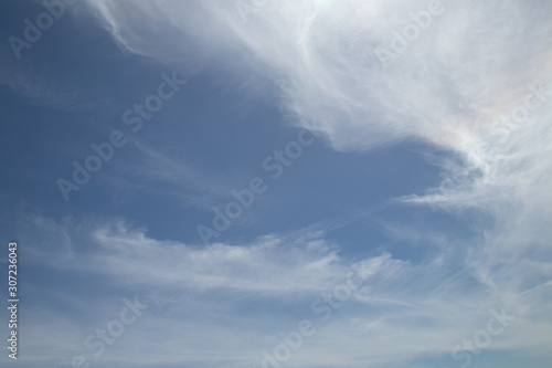 Photography Pale blue sky with swirling clouds on top and bottom