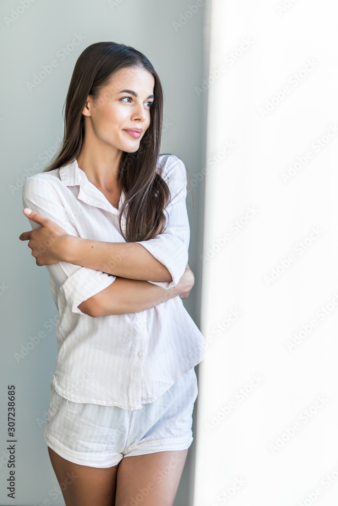 Young attractive woman looking in the window the morning, Young attractive woman looking in the window the morning,