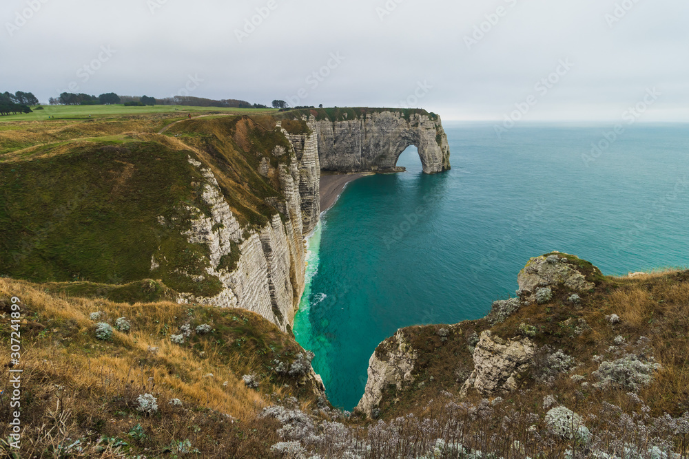 Panoramatic view on Etretat steep rock coastal cliffs at north of France, served as many inspiration for Monet, the impresionist painter