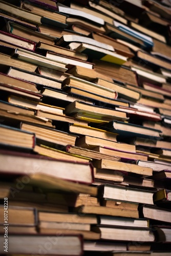 A huge pile of different books in the library. A library full of books. Reading. A huge number of books of different genres and sizes. Studying and education. Knowledge.