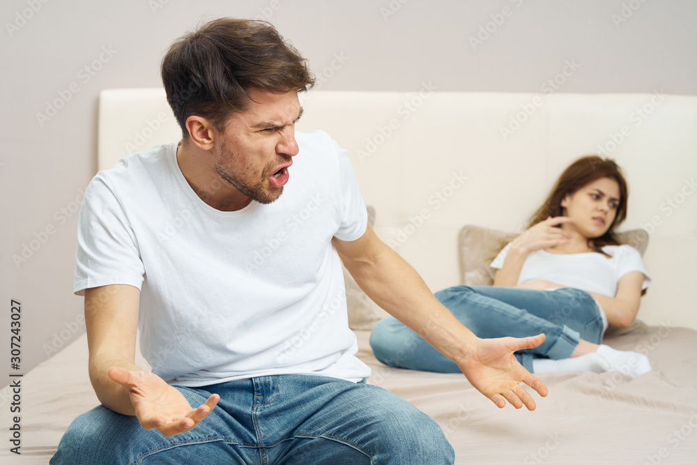 couple sitting on sofa and watching television couple sitting on sofa and watching television