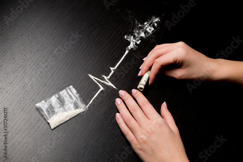 the woman is going to use cocaine, which is shown as a heartbeat line