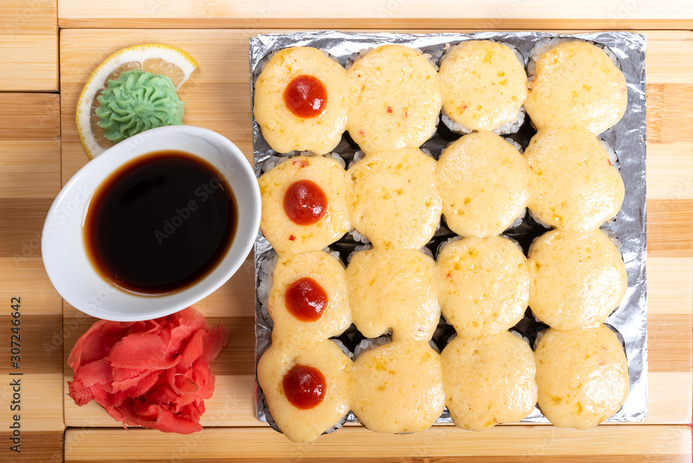 A large set of baked rolls with cheese caps. A large set of baked rolls with cheese caps.