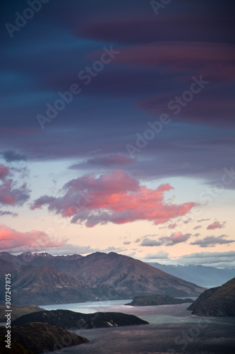 Sunrise sky mountain landscape. Early dawn morning colorful sky with scenic view over mountains in New Zealand. Roys Peak Wanaka