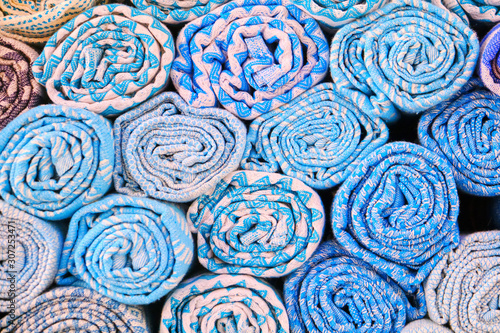 Background of rolled blue towels, close-up. Texture colored cloth at the Bazaar in the Medina