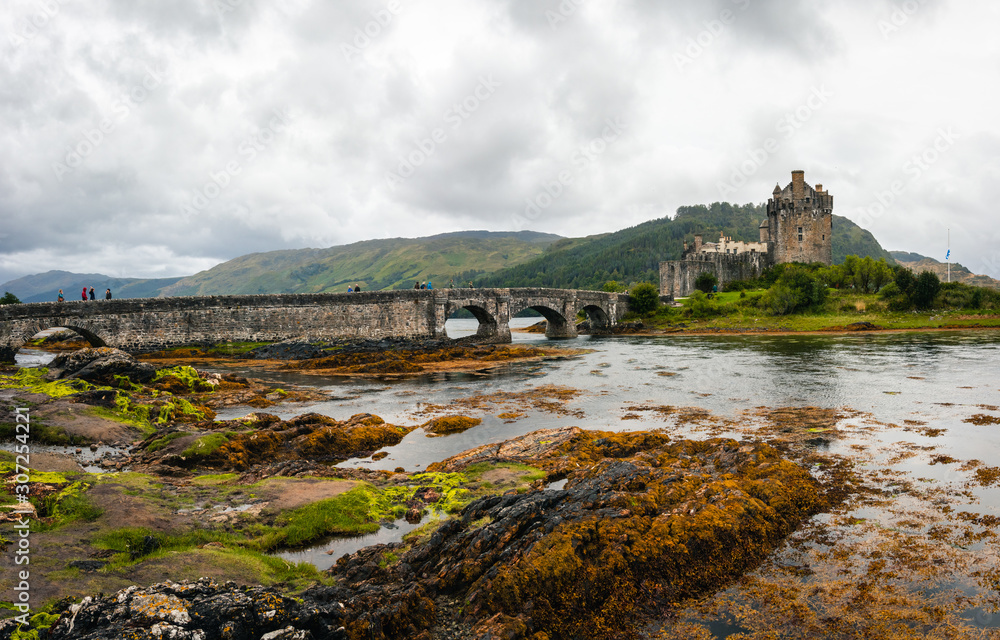 Magnificent Eilean Donan castle during cloudy weather at low tide