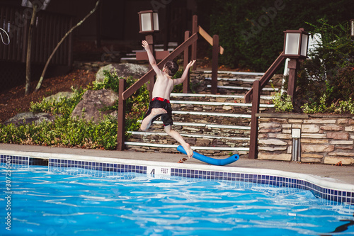 boy jumping in to the pool