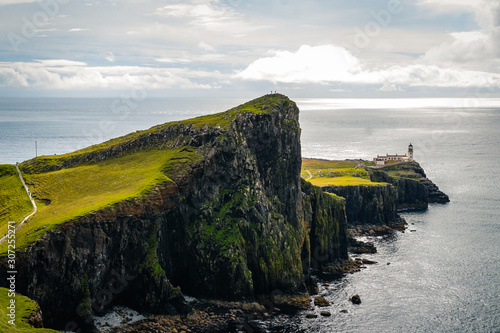 Famous lighthouse on isle of Skye in Scotland, Point nest, view over the approaching path, over the green meadow