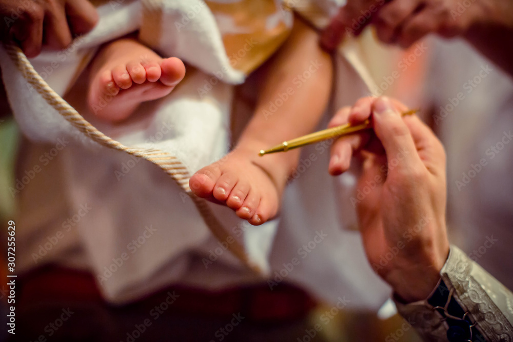 Church. To a little baby and a cross at the ceremony of baptism