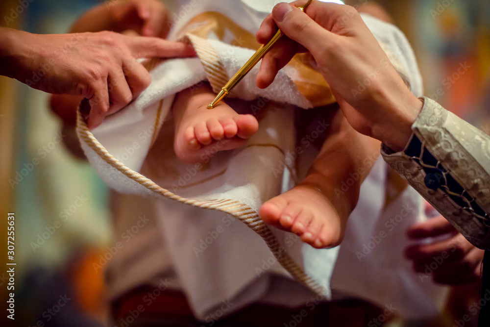 Church. To a little baby and a cross at the ceremony of baptism ...
