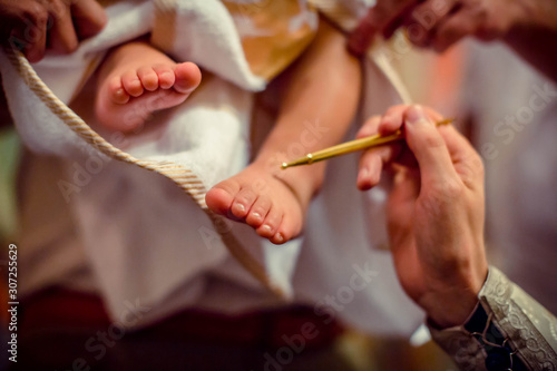 Church. To a little baby and a cross at the ceremony of baptism.Baptizing a child