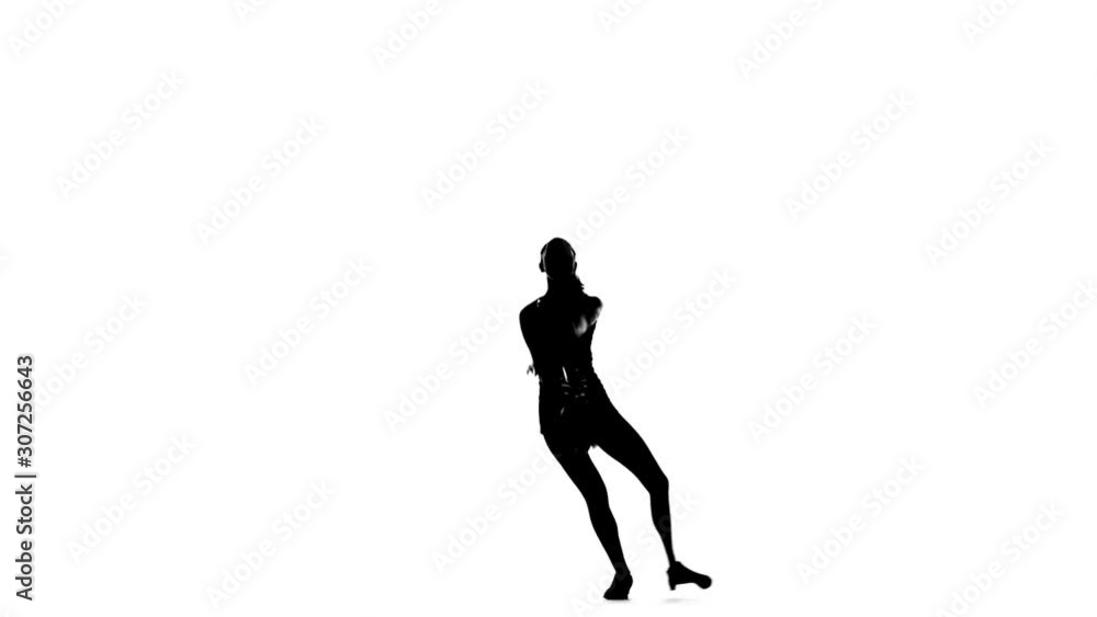 Young cheerleader with pom-poms smiling at camera, acrobatic wheel, Silhoutte, slow motion Young cheerleader with pom-poms smiling at camera, acrobatic wheel, Silhoutte, slow motion