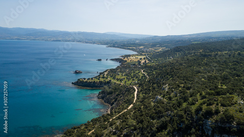 A beach by the sea or ocean, surrounded by cliffs and forests. Great places for traveling and outdoor recreation. Top view of the drone.