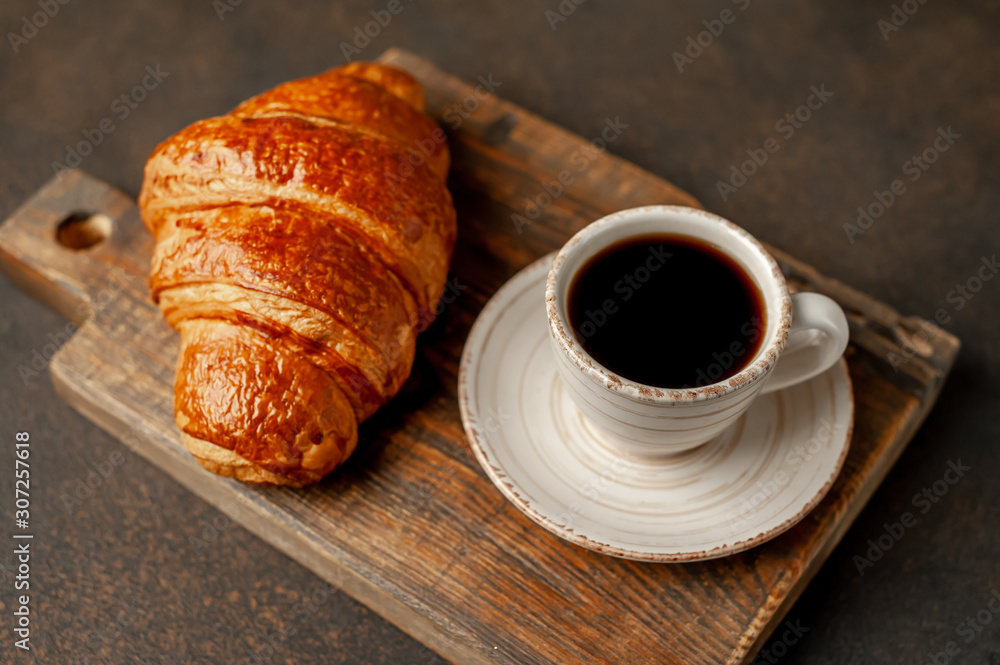 coffee and croissant on a stone table with copy space for your text, early breakfast concept coffee and croissant on a stone table with copy space for your text, early breakfast concept