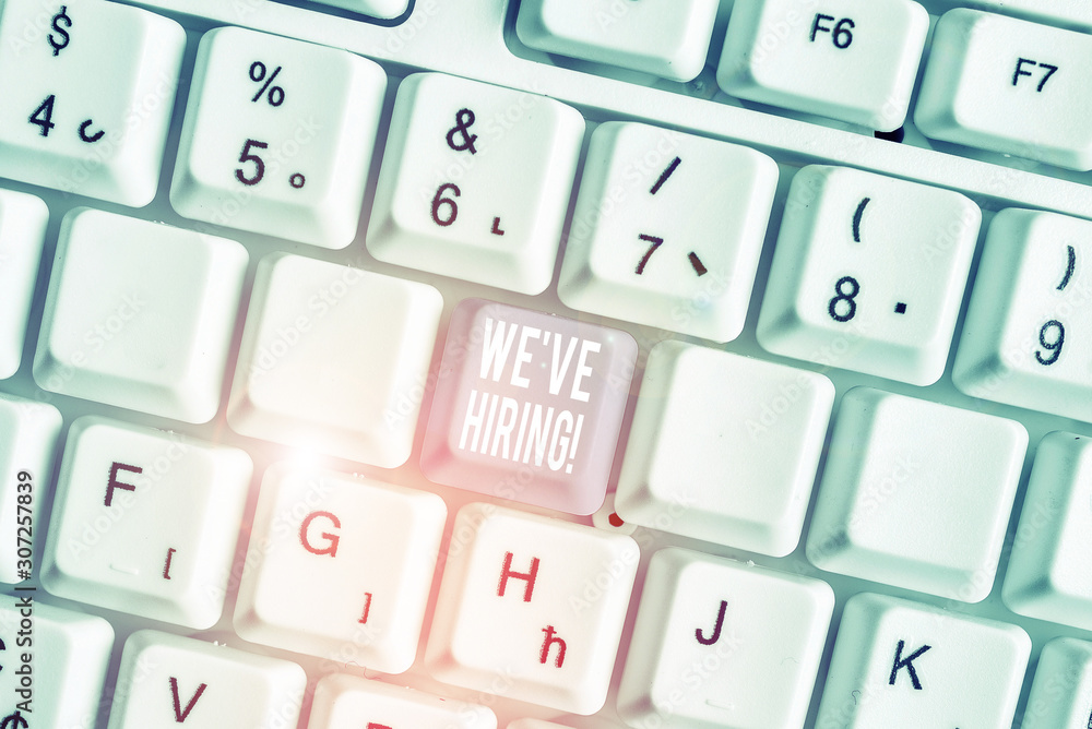 Word writing text We Are Hiring. Business photo showcasing recently you employ someone or pay someone to do particular job White pc keyboard with empty note paper above white background key copy space Word writing text We Are Hiring. Business photo showcasing recently you employ someone or pay someone to do particular job White pc keyboard with empty note paper above white background key copy space